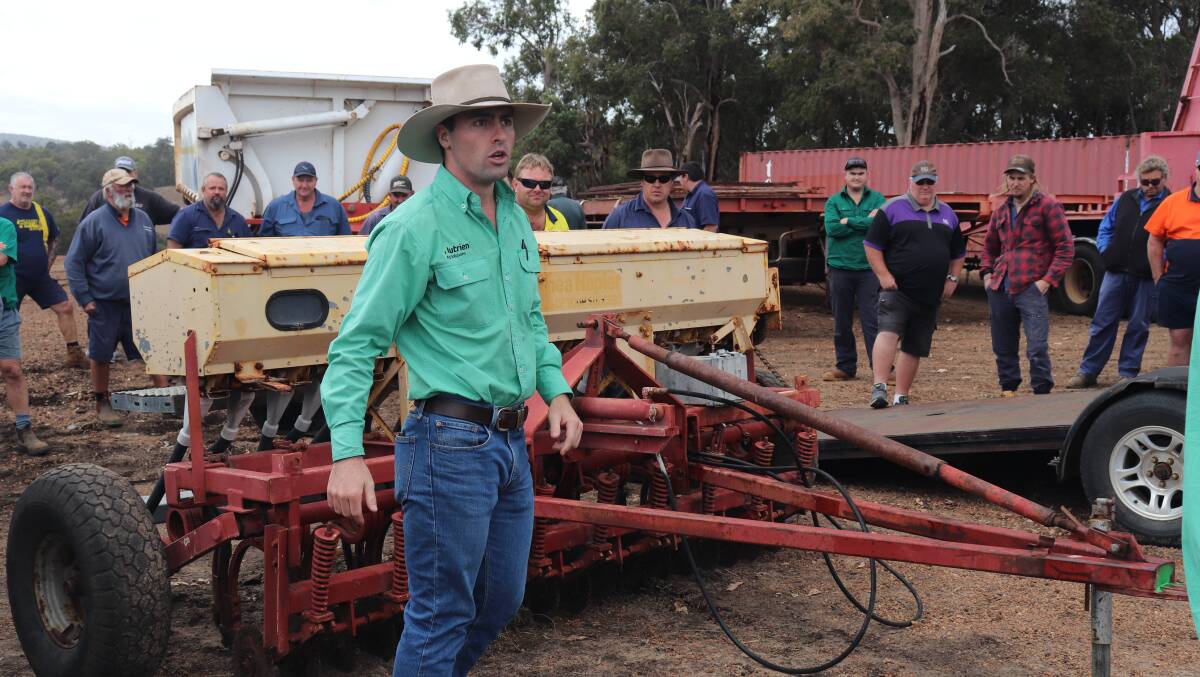 Nutrien auctioneer Austin Gerhardy seeking bids on the Connor Shea Napier seeder. It sold for $8500.