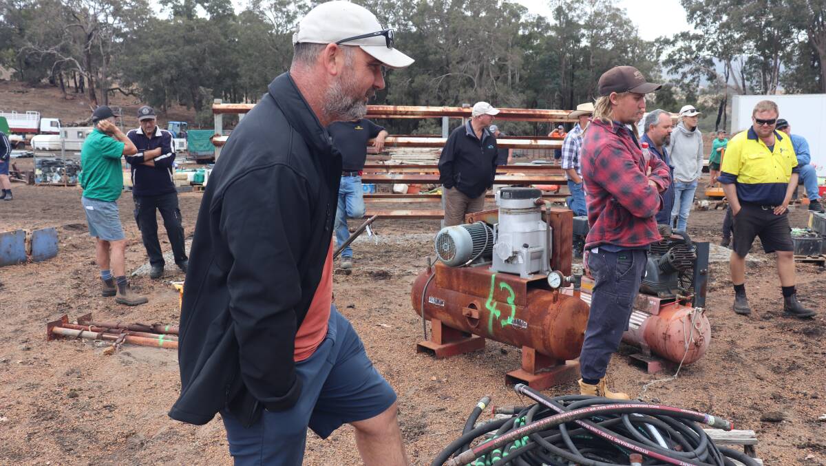 Simon Panette, Harvey, checking out some hydraulic hoses prior to the auction, which sold for $140.