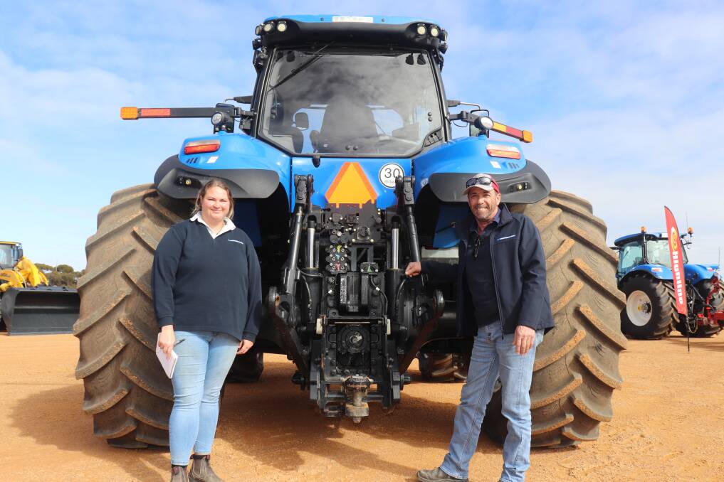 Paige Barry and Darryl Booth, both from the parts section of McIntosh & Son, Wongan Hills, at the business end of a New Holland Genesis T8.410 tractor.
