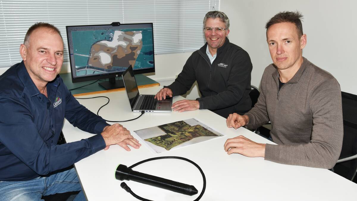 The Carbon Ag Technologies team, including Brad Wisewould (left), Carbon Ag, Wes Lawrence, AxisTech and Damon Buckley, who is leading the development of an in-ground soil scanning probe, discuss some of the paddock maps produced from data collected by the iScan deep soil mapping module that is mounted on seeding bars.