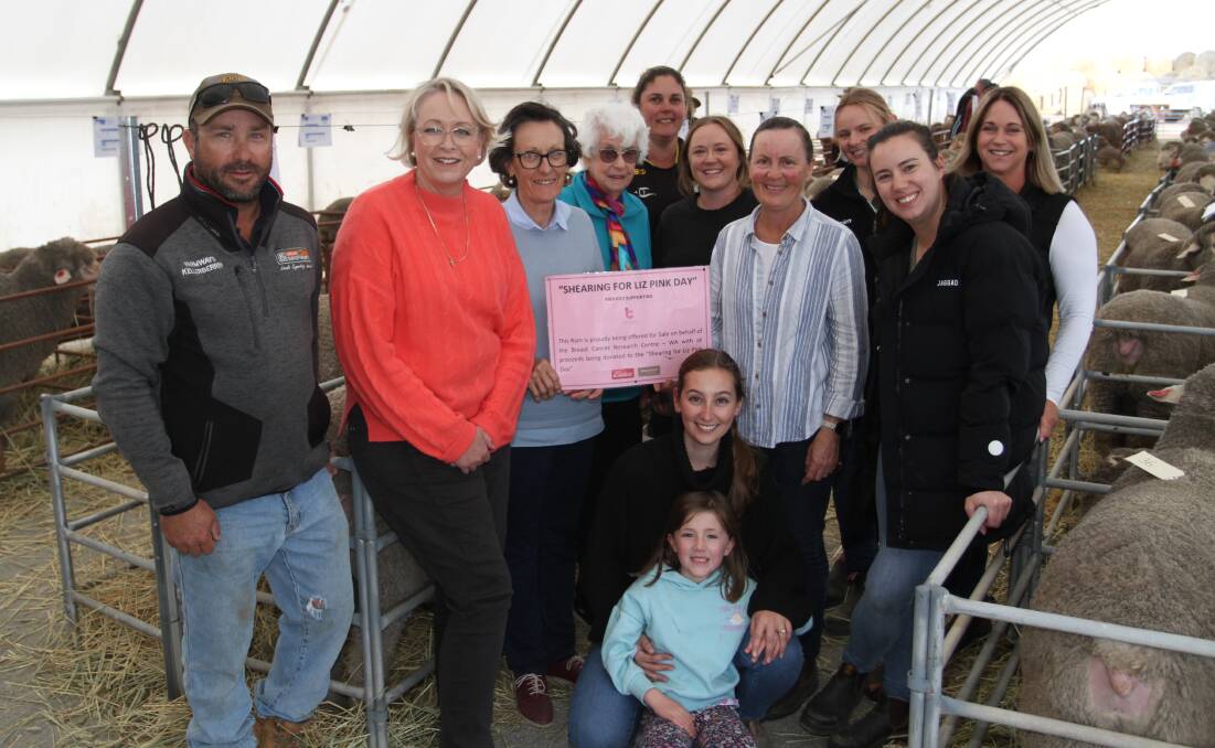 The Button family donated the proceeds of a sale ram to the Shearing For Liz Pink Day fundraiser. Celebrating the $2800 raised for Breast Cancer Research Centre WA, were ram buyer Paul Giles (left), E Giles & Co, Doodlakine, Sian Whitfield, Konnongorring, Barbara Cumming, Wagin, Joan Button, Manunda stud, Jen Szczecinski, Corrigin, Emma and Pip Button, Manunda stud, Dayna Hutchison, Nutrien Ag Solutions, Merredin, Lauren Cole, York, Sheree Hill, Cunderdin, Rowie Snooke (kneeling), Manunda stud with Olive Cole.