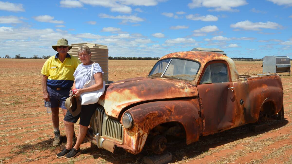 Duncan and Betty Avery, Manmanning, with the rusty remains of a 48-215 FX Holden ute that sold for $950. An equally rusty 1940s Pontiac sedan in similar garden art condition also sold for $950.