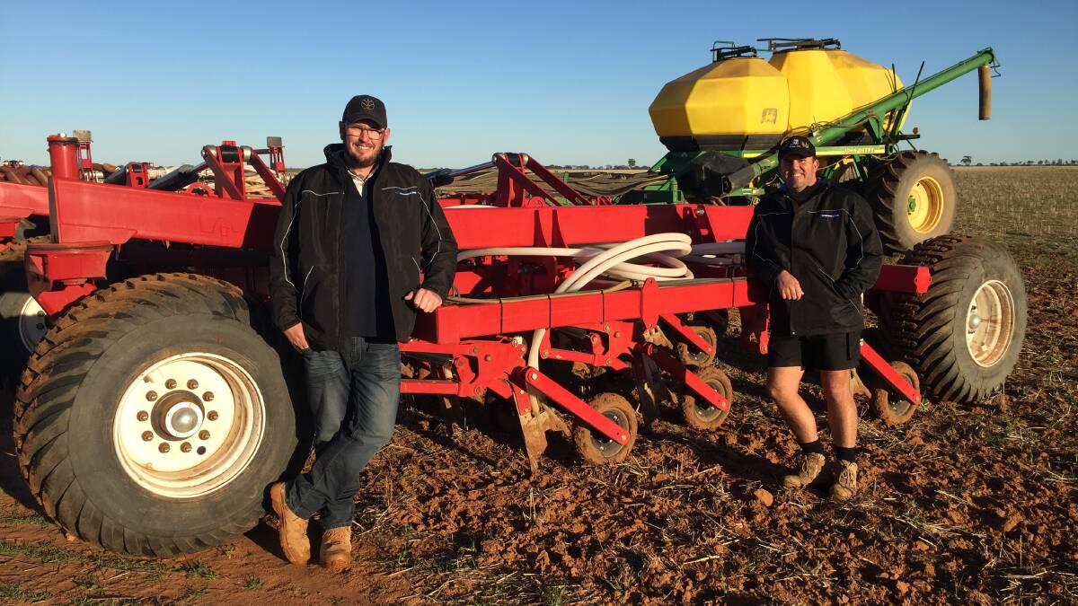 Corey Harken (left), McIntosh & Son Merredin, with Brad O'Meagher and the family's Quantum air drill and John Deere air cart sowing rig on their property between Kununoppin and Nungarin.