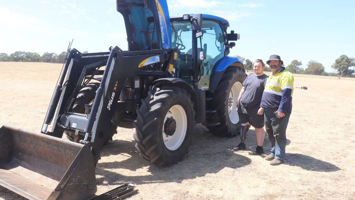 John Blair (left) and Jeremy Blair, both Kojonup, before the sale. The T6030 New Holland tractor with bucket and forks sold for $76,000.
