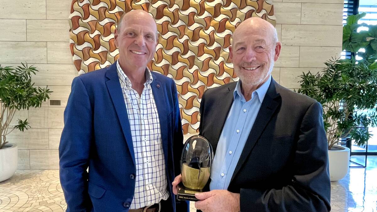 GRDC chairman John Woods (left), presents Terry Enright with the Seed of Gold award at the GRDC Grains Research Update, Perth, on Monday morning.
