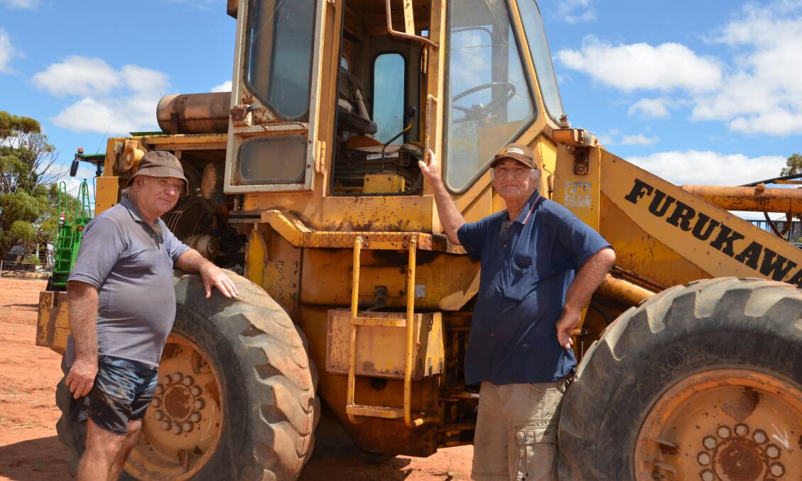 Brothers Garry (left) and Brett Scally, Goodlands, inspecting an old Furukawa wheel loader that was bought for $200 by Alan Wills, Westonia, who also bought an ancient Caterpillar D8 bulldozer.