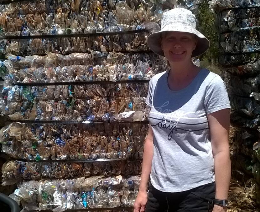 Ella Maesepp visited a recycling centre a few years ago. She's standing in front of bales of plastics that were being stockpiled until someone can do something about them, which is why she's so passionate about not creating the waste in the first place, rather than trying to clean it up (recycle) it once it's already made. Photo supplied.