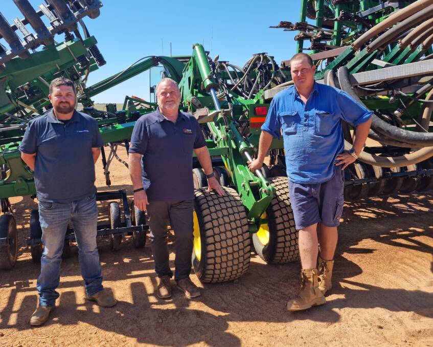 Michael Marwick (left), McIntosh & Son Geraldton, Ray Gilham, Farmscan, and Walkaway grower Josh Garratt discuss the effectiveness of the Intelligent Ag Recon Wireless Blockage and Flow Monitor system used on the family's 15-metre (50-foot) John Deere 1830 air drill.