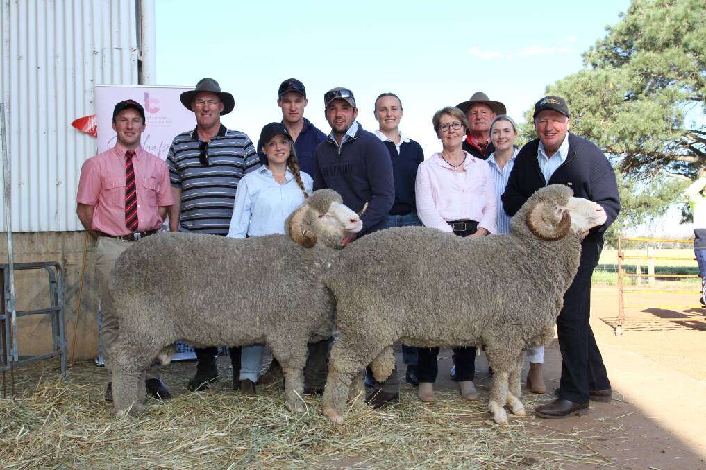 The Doyle family, Wylivere Farms, Corrigin, purchased three Merino rams at the annual Woodyarrup on-property ram sale at Broomehill last week for the sales $13,500 top price, $8750 and $7500. With the $13,500 (left) and $7500 rams were Elders auctioneer and Gnowangerup representative James Culleton (left), buyers Greg and Ben Doyle, Wylivere Farms, Woodyarrups Minou Runkel, Lachlan Dewar, Sandra Gianoli, Isabella and Craig Dewar, Woodyarrup stud co-classer Russell McKay (rear right), Elders stud stock and his daughter Abby (to his right).