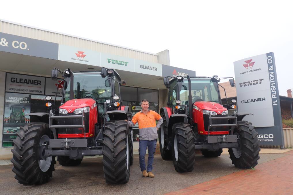 Mr Rushton with two of his Massey Ferguson stock out the front of H Rushton & Co in Robinson Road, Brookton. The new service centre is being completed fronting Richardson Street, the street behind these premises.
